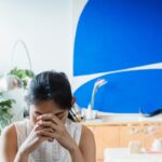 Girl bowing head while telling her story to her counselor Benefit From Counseling