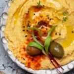 Mediterranean Diet of brightly colored yellow humus olives and spices